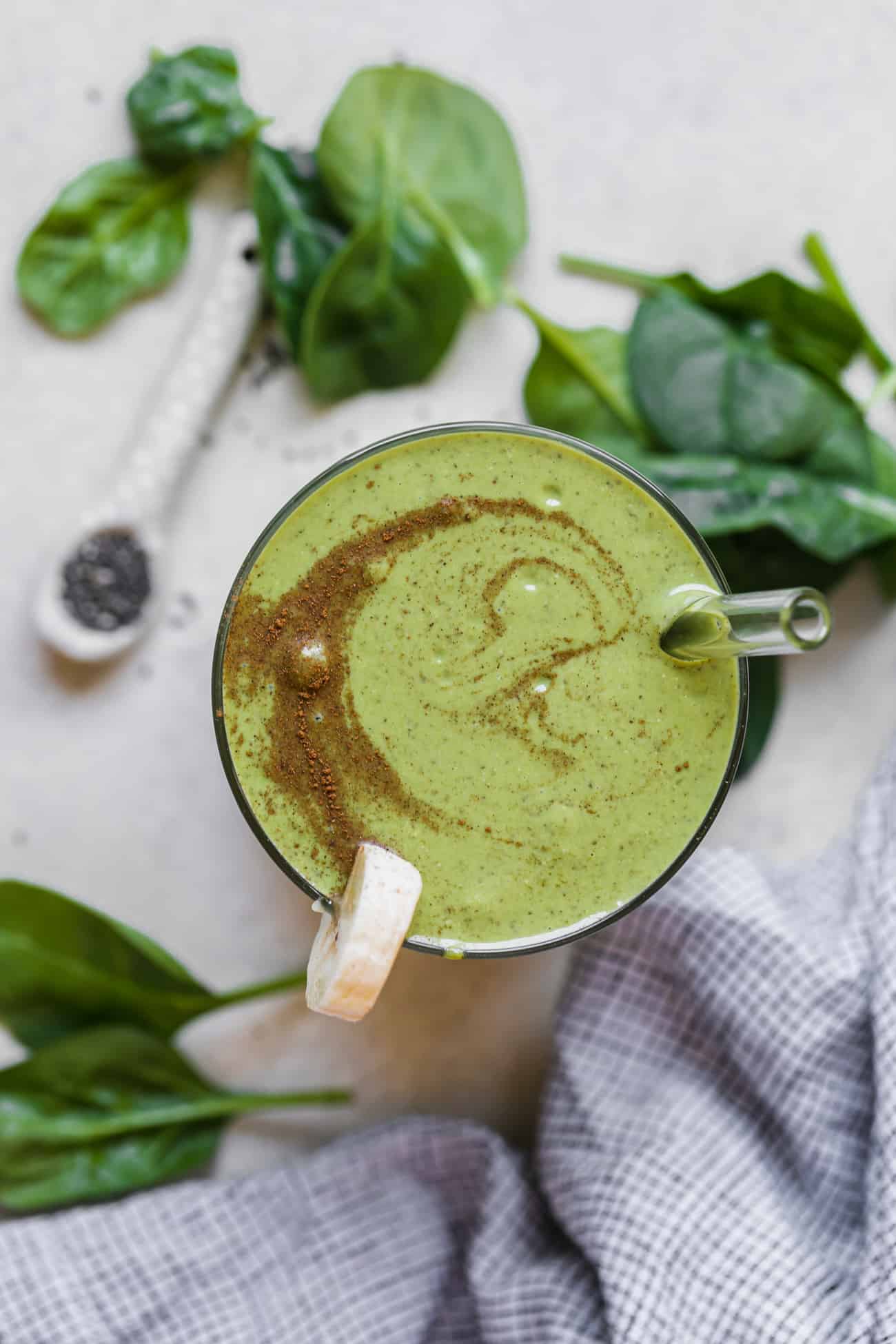 banana and spinach smoothie with sliced banana and cinnamon on top