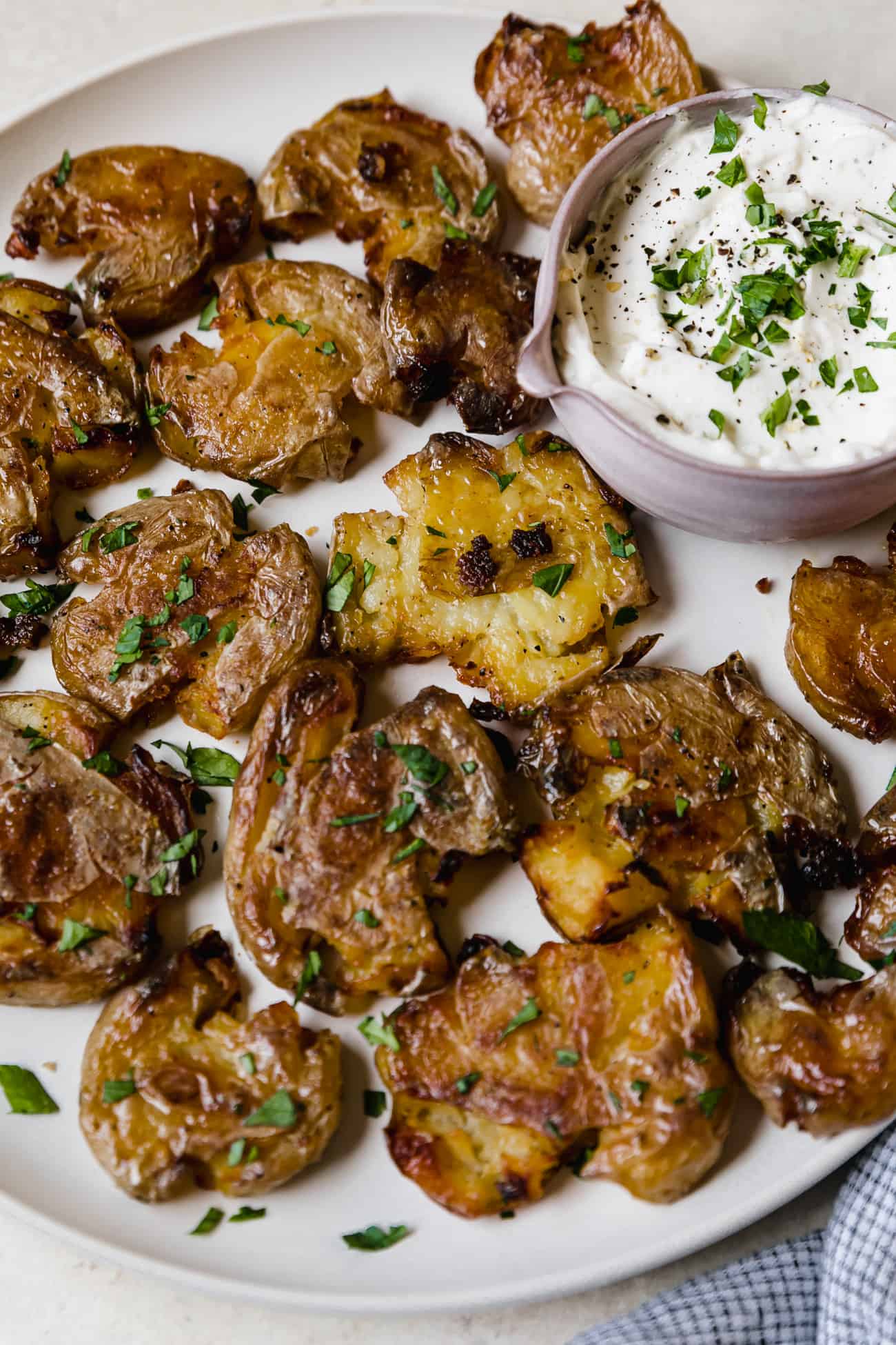 cooked baby smashed potatoes with fresh parsley on top